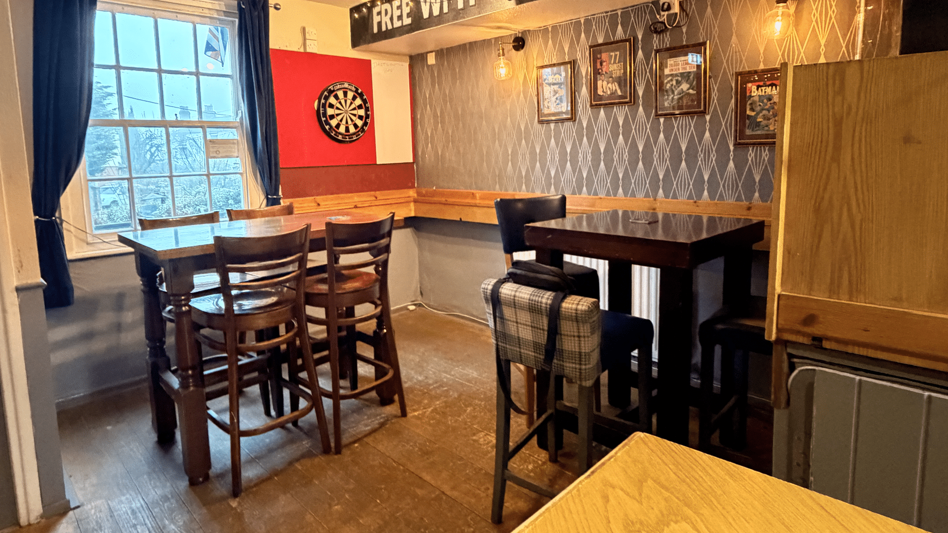 Tables and dart board at the Six Bells