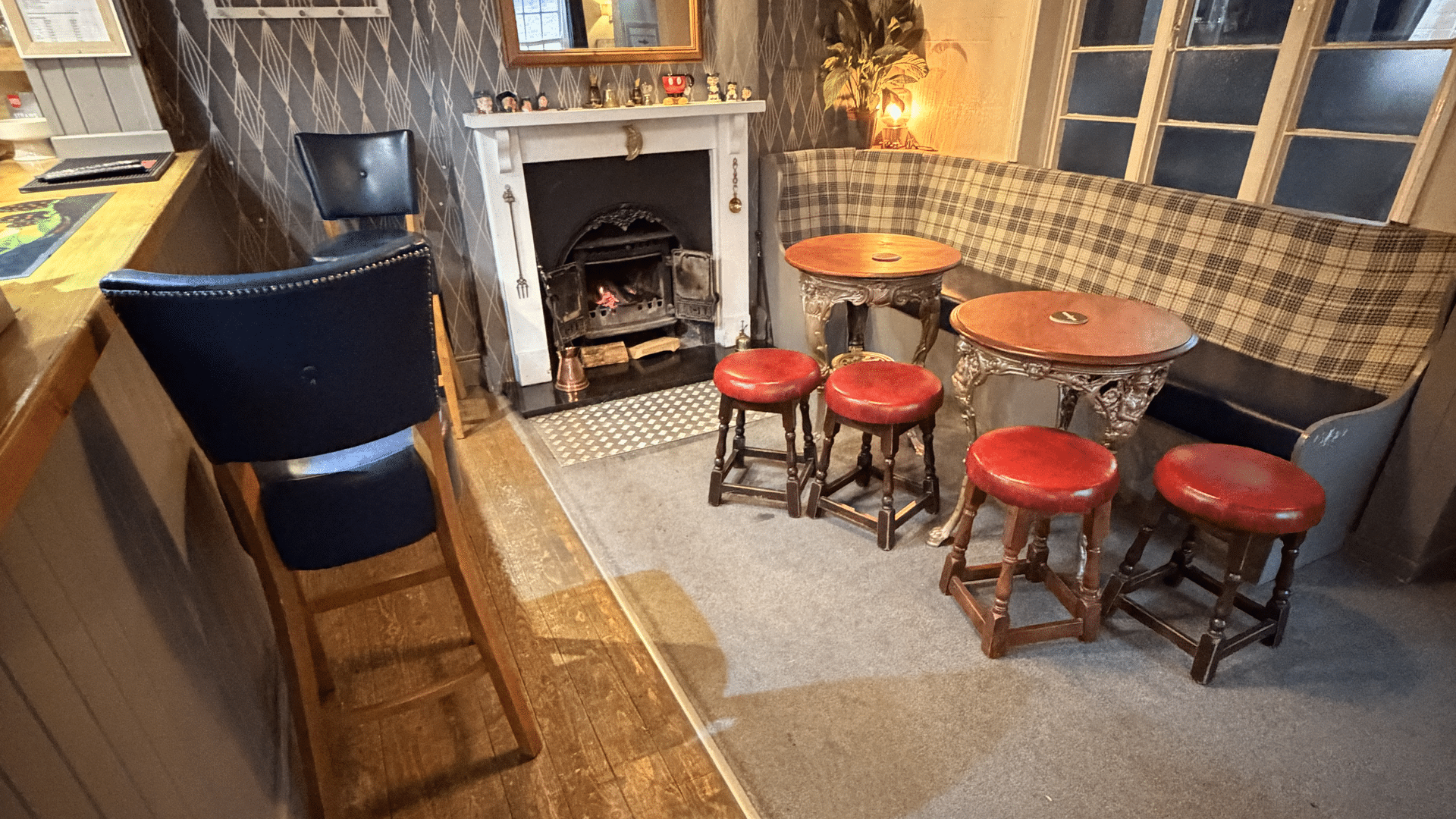 Fireplace and stools at The Six Bells
